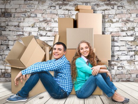 Trained movers handling furniture with safety equipment